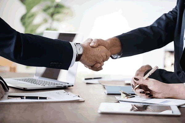 People shaking hands after an influence marketing deal
