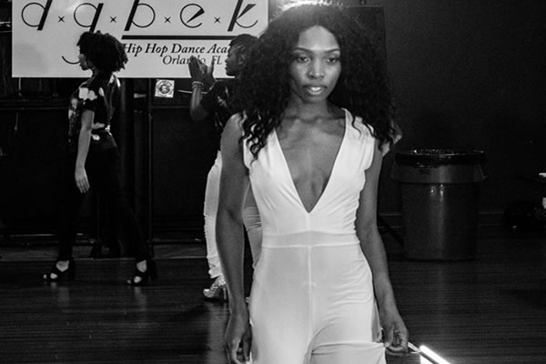 Woman walking the runway at an event advertised by COSMarketing Agency