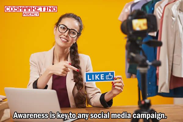 Woman pointing at a card with a "Like Button" printed on it.