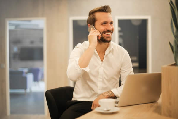 Man talking on the phone for networking purposes.