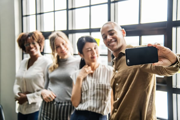 People taking a selfie together after reading a blog on top 3 marketing trends for small businesses by COSMarketing Agency