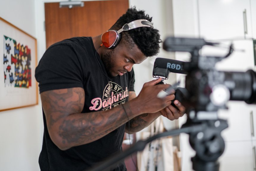 Guy recording with a camera setup for video marketing purposes.