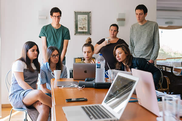 Workers at a desk talking about their digital marketing careers